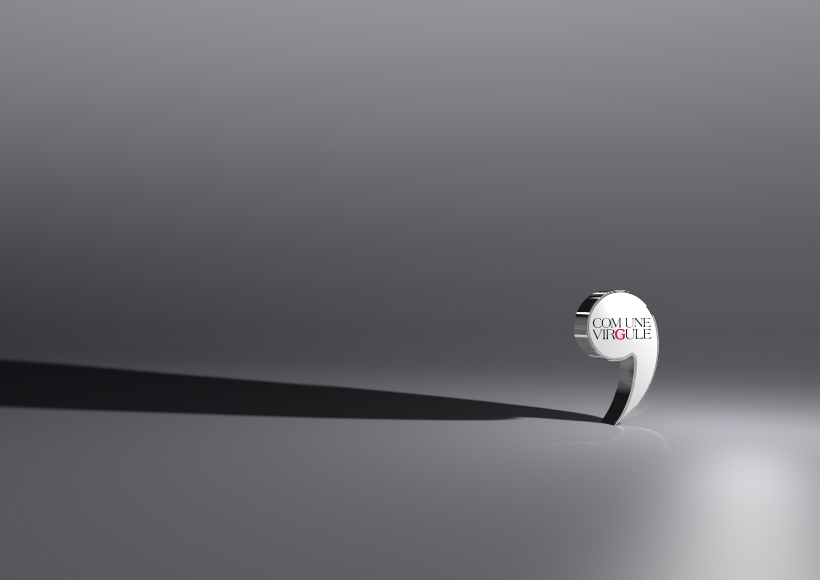 Logo Com Une Virgule sur fond gris